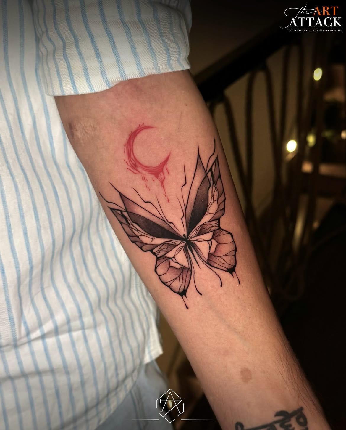 Fine-line floral tattoo trailing across a shoulder and upper back.