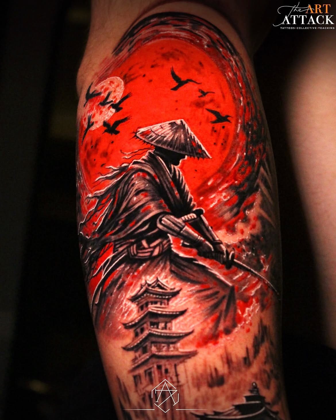 Japanese-style sleeve tattoo of a figure beneath a large red sun, with pagoda and cloud work.